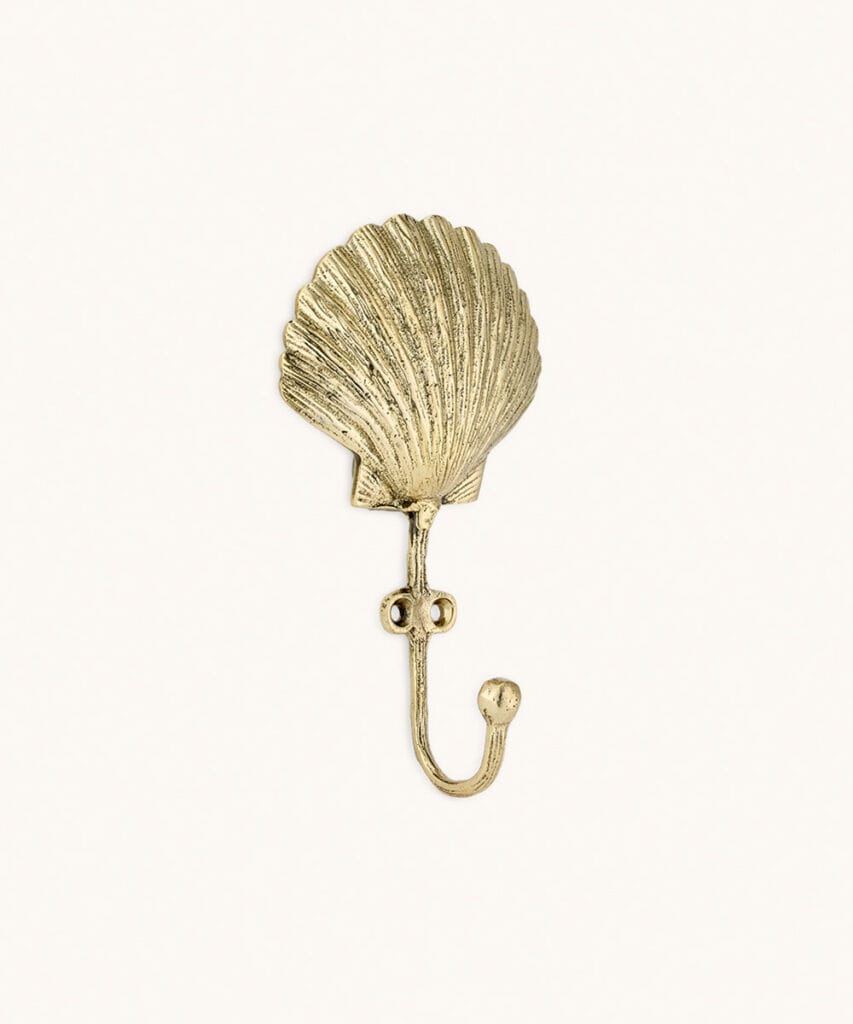 Scarlett Shell Hook from Doing Goods in recycled brass shaped like a decorative seashell.